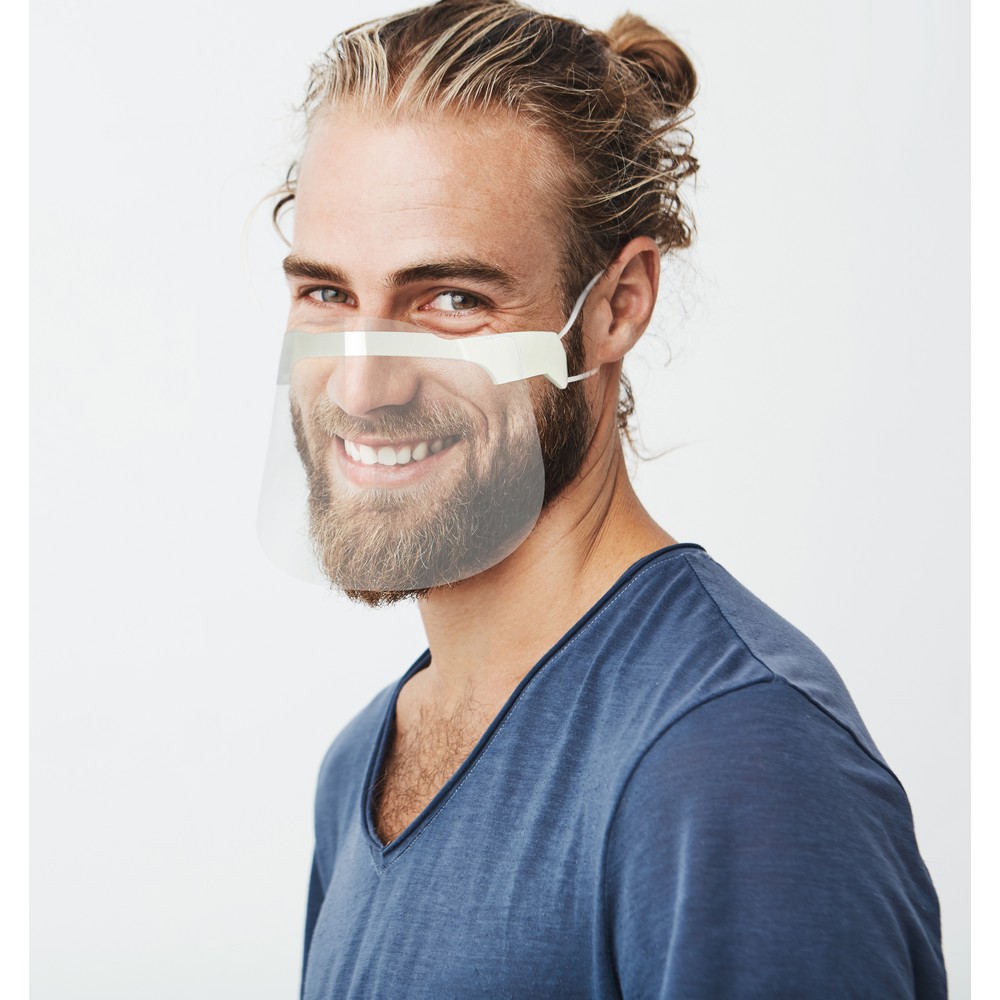Happy young bearded guy with fashionable hairstyle and beard looking at camera, brightfully smiling with teeth, being happy about day off on work.